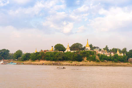 Buddha statue on the bank of the river Irrawaddy, Mandalay, Myanmar, Burma. Copy space for text