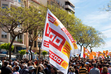 Tarragona, Spain - 01, 05, 2017: People with flags at the street of Tarragona at the 1st of may, international celebrationのeditorial素材