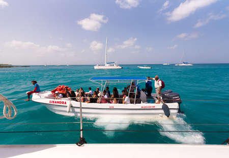 SAONA, DOMINICAN REPUBLIC - MAY 25, 2017: Group of tourists in a boat. Copy space for textのeditorial素材