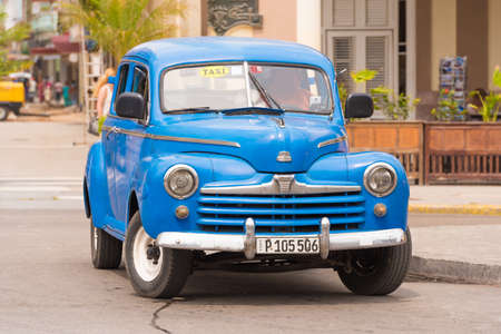CUBA, HAVANA - MAY 5, 2017: A blue American retro car on a city street. Copy space for textのeditorial素材