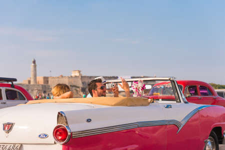 CUBA, HAVANA - MAY 5, 2017: American pink retro-cabriolet on the lighthouse background. Copy space for text. Close-upのeditorial素材