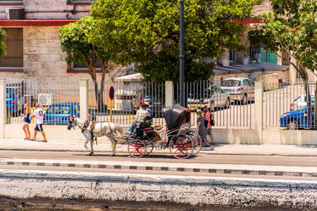 CUBA, HAVANA - MAY 5, 2017: An open carriage rides along the embankment. Copy space for textのeditorial素材