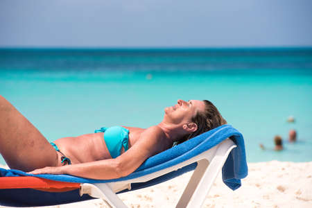 CAYO LARGO, CUBA - MAY 10, 2017: Woman on the beach sunning. Copy space for textのeditorial素材