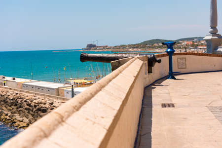 Ancient tools on the fortress wall. Fortress cannon in Sitges, Barcelona, Catalunya, Spain. Copy space for textのeditorial素材