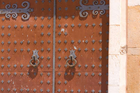 Antique wrought iron door of a church of Sant Bartomeu and Santa Tecla in Sitges,  Barcelona, Catalunya, Spain. Close-upの写真素材