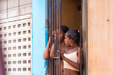 CUBA, HAVANA - MAY 5, 2017: Two cuban girls near the lattice. Copy spaceのeditorial素材