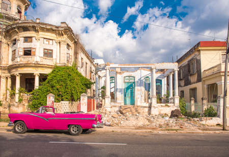 CUBA, HAVANA - MAY 5, 2017: American pink retro cabriolet on the background of buildings. Copy space for textのeditorial素材