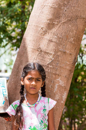 PUTTAPARTHI, ANDHRA PRADESH, INDIA - JULY 9, 2017: Portrait of  Indian cute girl on the street. Close-up. Verticalのeditorial素材