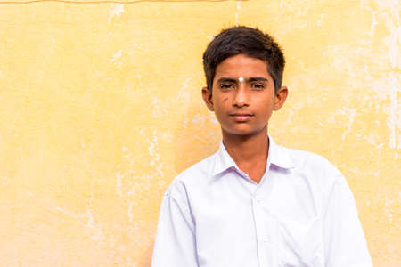 PUTTAPARTHI, ANDHRA PRADESH, INDIA - JULY 9, 2017: Portrait of an Indian guy in a white suit. Close-upのeditorial素材