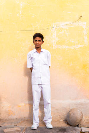PUTTAPARTHI, ANDHRA PRADESH, INDIA - JULY 9, 2017: Indian guy in white suit. Copy space for text. Verticalのeditorial素材