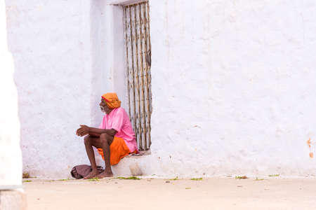 PUTTAPARTHI, ANDHRA PRADESH, INDIA - JULY 9, 2017: An elderly man in a rural street. Copy space for...