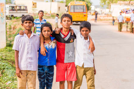 PUTTAPARTHI, ANDHRA PRADESH, INDIA - JULY 9, 2017: A group of Indian boys in a village street. Copy space for textのeditorial素材