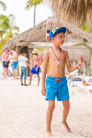 SAONA, DOMINICAN REPUBLIC - MAY 25, 2017: Boy on the sandy beach of the island. Copy space for text. Verticalのeditorial素材