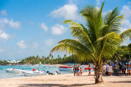 BAYAHIBE, DOMINICAN REPUBLIC - MAY 21, 2017: Tourists near boats. caribbean landscape. Copy space for textのeditorial素材