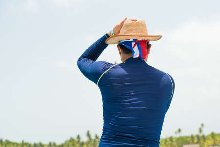 The man in the hat on the beach in Bayahibe, La Altagracia, Dominican Republic. Copy space for text....
