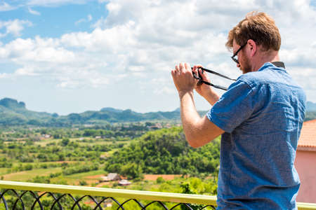 VINALES, CUBA - MAY 13, 2017: Man on the background of Vinales valley. Copy space for textのeditorial素材