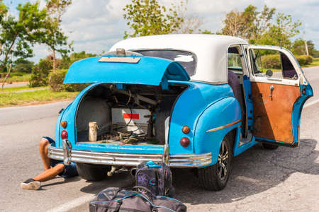The legs of a man under the car, Vinales, Pinar del Rio, Cuba. Car repairs. Close-upの写真素材