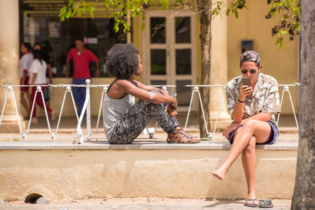 VINALES, CUBA - MAY 13, 2017: Man and woman are resting on a city street. Close-upのeditorial素材