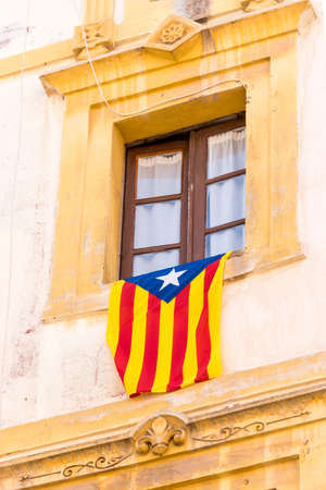 The flag Estelada on the facade of the building. Before the referendum on independence, Tarragona, Catalonia, Spain. Close-up. Verticalの写真素材