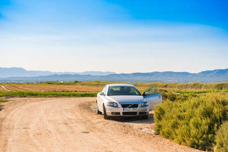 EBRO DELTA, TARRAGONA, SPAIN - SEPTEMBER 19, 2017: Landscape of the Ebro Delta, a car in a field.のeditorial素材