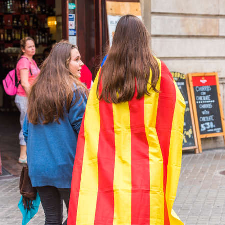 BARCELONA, SPAIN - OCTOBER 3, 2017: Demonstrators bearing catalan flag during protests for...