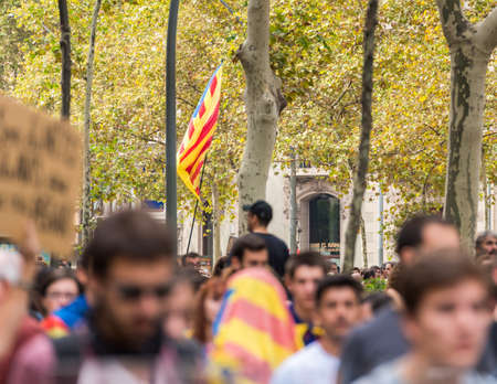 BARCELONA, SPAIN - OCTOBER 3, 2017: Demonstrators bearing catalan flag during protests for...