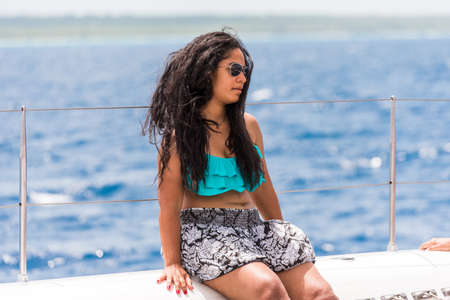 SAONA, DOMINICAN REPUBLIC - MAY 25, 2017: The girl is sitting on the deck of the yacht. Copy space for textのeditorial素材