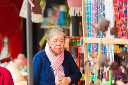 LOUANGPHABANG, LAOS - JANUARY 11, 2017: An elderly woman in the city market. With selective focusのeditorial素材