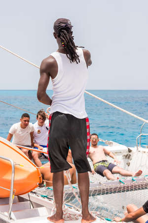 SAONA, DOMINICAN REPUBLIC - MAY 25, 2017: A group of people on a yacht. Close-up. Verticalのeditorial素材