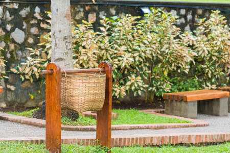 Wicker basket for garbage on a city street in Louangphabang, Laos. Copy space for textの写真素材