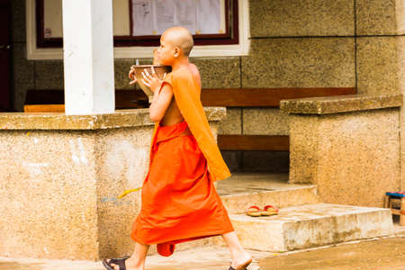 LOUANGPHABANG, LAOS - JANUARY 11, 2017: Monks on a city street. Copy space for textのeditorial素材