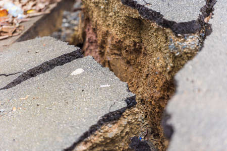 Asphalt road cracked and broken from earthquake, Louangphabang, Laos. Close-upの写真素材