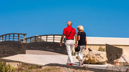 LEUCATE, FRANCE - SEPTEMBER 8, 2017: Couple walking along the promenade. Copy space for textのeditorial素材