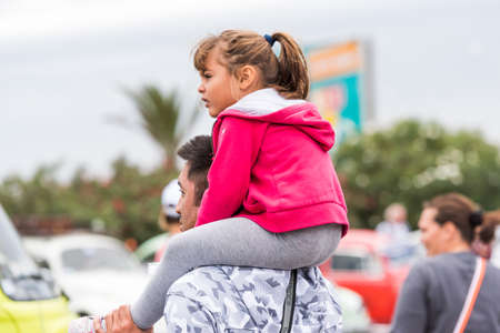 AGDE, FRANCE - SEPTEMBER 9, 2017: A child sits on a man's neck. Copy space for textのeditorial素材