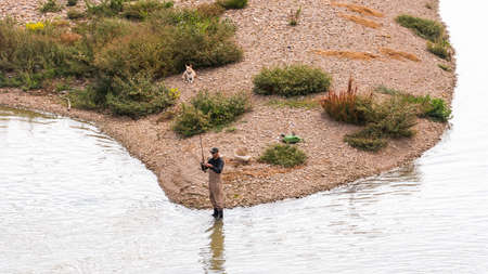 SARAGOSSA, SPAIN - SEPTEMBER 27, 2017: Fisherman on the river Ebro. Copy space for textのeditorial素材