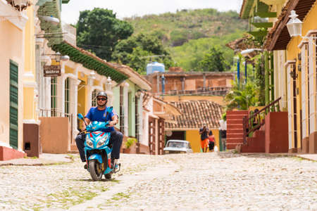 TRINIDAD, CUBA - MAY 16, 2017: A man on a motorcycle on a city street. Copy space for textのeditorial素材