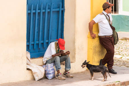TRINIDAD, CUBA - MAY 16, 2017: Cuban men on a city street. Copy space for textのeditorial素材