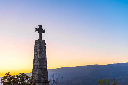Memorial Cross and Church of Santa Maria de Siurana in Siurana de Prades, Tarragona, Spain. Copy space for textの写真素材