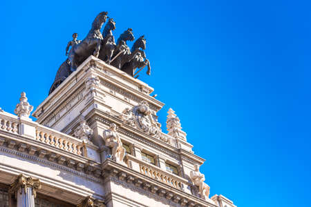MADRID, SPAIN - SEPTEMBER 26, 2017: Sculpture of a chariot, over a bank building on the street Alcala. Copy space for text.のeditorial素材