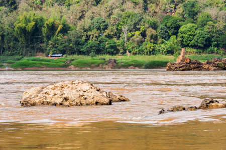 View of the stony bank of the river Nam Khan, Louangphabang, Laos.の写真素材