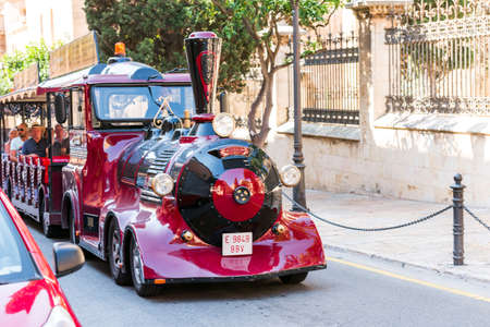 TARRAGONA, SPAIN - OCTOBER 4, 2017: Excursion steam locomotive. Tourists on a walk. Copy space for...