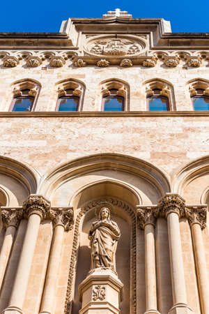 TARRAGONA, SPAIN - OCTOBER 4, 2017: Statue on the facade of the building of the Tarragona Cathedral (Catholic cathedral) on a sunny day. Vertical. Bottom viewのeditorial素材