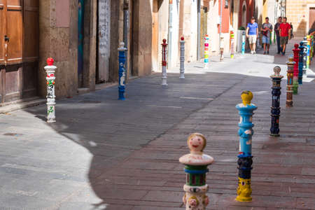 TARRAGONA, SPAIN - SEPTEMBER 17, 2017: Painted pillars on a city street. Copy space for textのeditorial素材