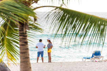 BAYAHIBE, DOMINICAN REPUBLIC - MAY 21, 2017: Couple on a sandy beach. Copy space for textのeditorial素材