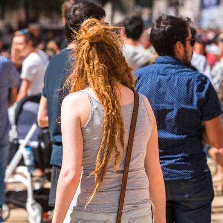 TARRAGONA, SPAIN - SEPTEMBER 17, 2017: Girl with curly hair on holiday Santa Tecla. Close-up