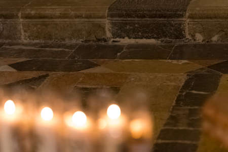 Candles in Tarragona (Catholic Cathedral), Catalonia, Spain. Copy space for text. Selective focus. Bokehの写真素材