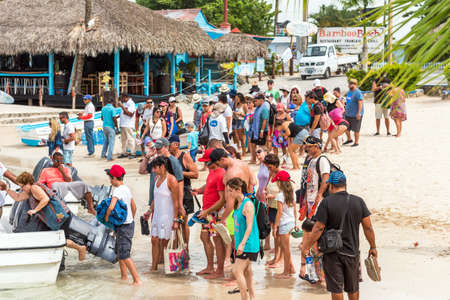 BAYAHIBE, DOMINICAN REPUBLIC - MAY 21, 2017: Tourists get into boat. Copy space for textのeditorial素材
