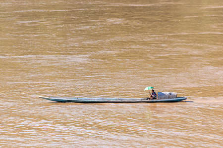 LOUANGPHABANG, LAOS - JANUARY 11, 2017: Boat offshore Nam Khan river. Copy space for textの写真素材
