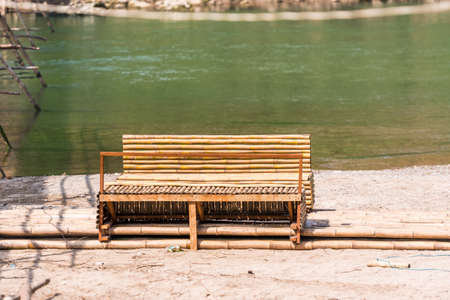 Bamboo bench on the background of water, Louangphabang, Laos. Copy space for textの写真素材