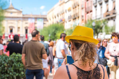 TARRAGONA, SPAIN - SEPTEMBER 17, 2017: Woman in a yellow hat on holiday Santa Tecla. Copy space for textのeditorial素材